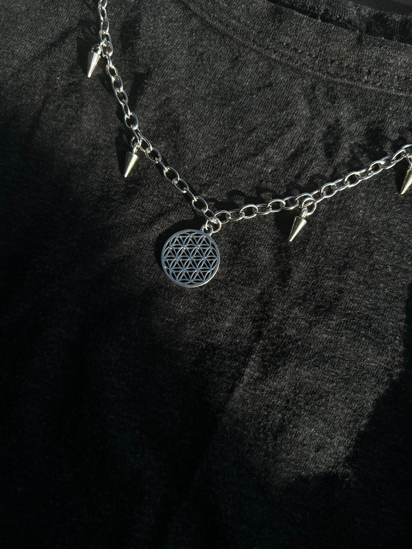 Spiked flower of life necklace.