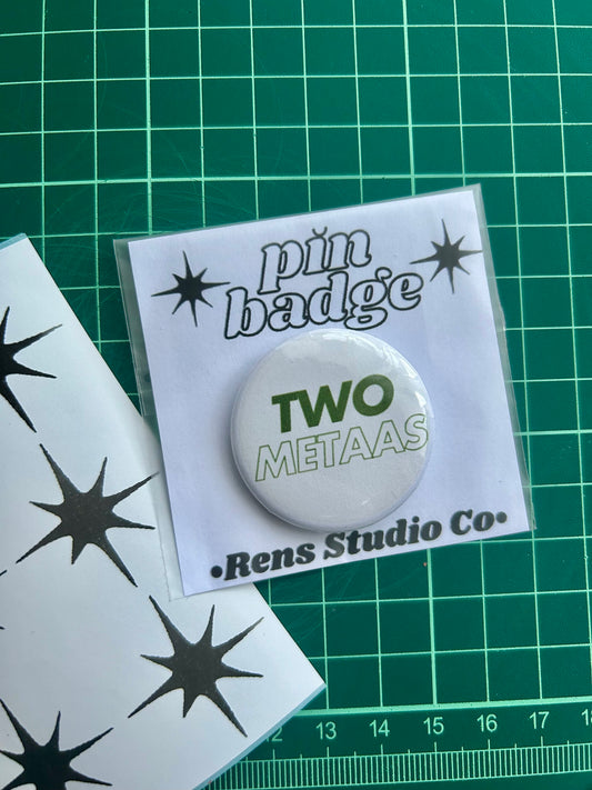 two metaas pin badge
