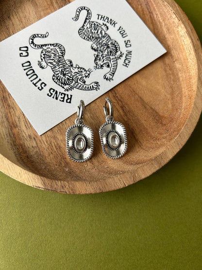 cowboy hat earrings | silver pair of hoop earrings